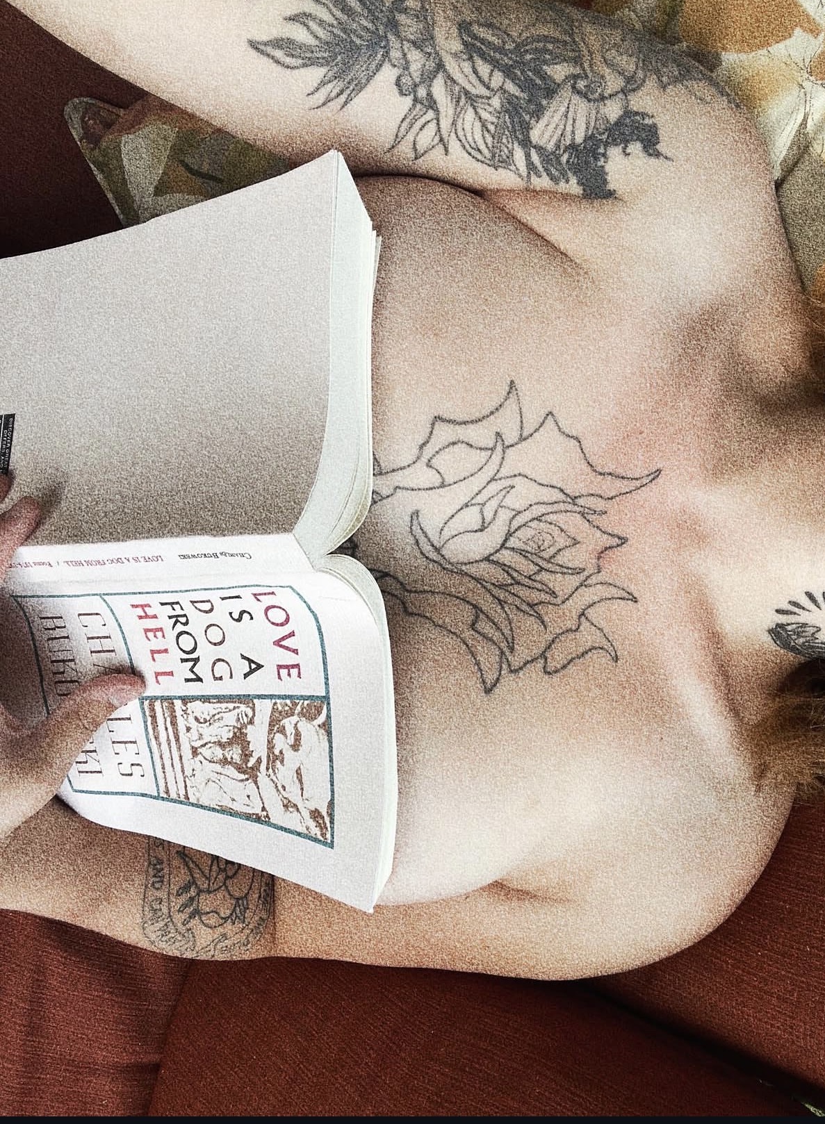Juliette reading Charles Bukowski’s Love Is a Dog from Hell, the open book resting against her